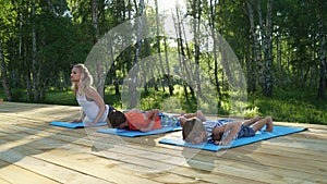 Young woman and children practicing yoga