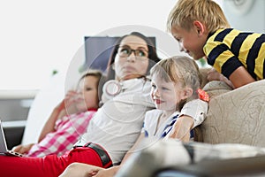 Young woman with children watching tv living room
