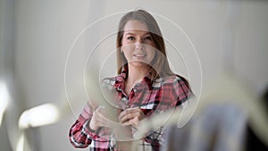 Young woman choosing clothes on a rack searching what to wear. Store or wardrobe