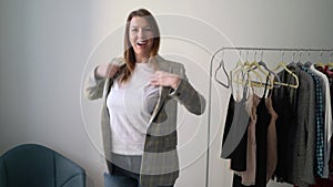 Young woman choosing clothes on a rack searching what to wear. Store or wardrobe