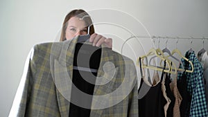 Young woman choosing clothes on a rack searching what to wear. Store or wardrobe