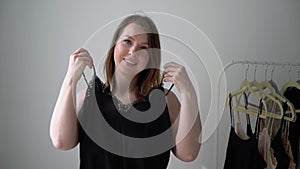 Young woman choosing clothes on a rack searching what to wear. Store or wardrobe