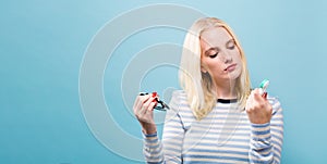 Young woman choosing between contact lenses or glasses