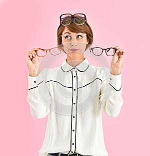Young woman choosing eyeglasses