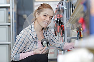 young woman choosing items hardware shopping