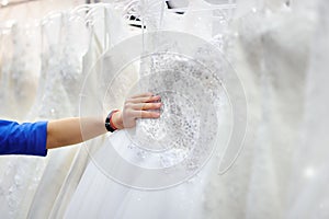 Young woman choosing the perfect bridal dress during bridal shopping