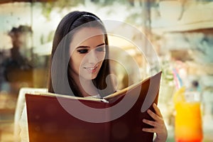 Young Woman Choosing from a Restaurant Menu