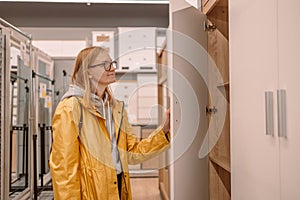 Young woman choosing the right furniture for her apartment in a modern home furnishings store shopping for furniture in