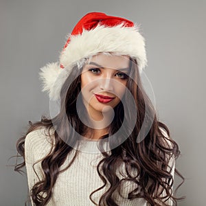 Young Woman Christmas. Nice Girl Model in Red Santa Hat