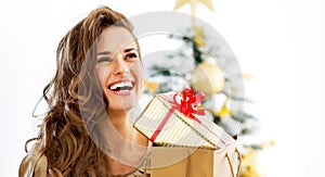 Young woman with christmas present boxes in front of