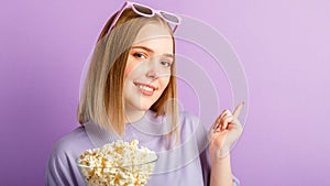 Young woman in cinema glasses watching 3d movie. Smiling teenager girl movie viewer in glasses with popcorn show with