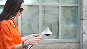 Young woman with a city map in city. Travel tourist girl with map in Vienna outdoors during holidays in Europe.