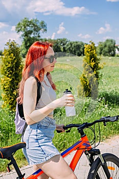 Young woman in the city rides bike and leads an active lifestyle doing sports