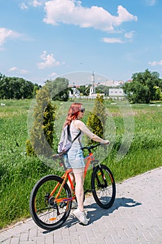 Young woman in the city rides bike and leads an active lifestyle doing sports