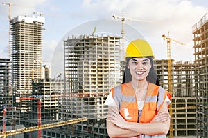 Young woman civil engineer on construction building background. Evolution construction concept.