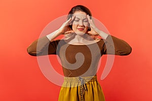 Young woman clasp head and feeling headache