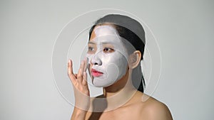 Young woman clay face mask peeling natural with purifying mask on her face