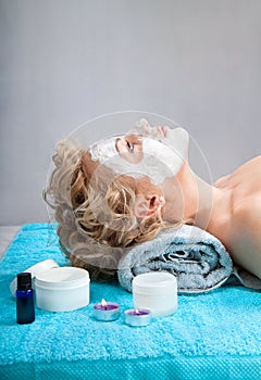 Young woman with clay facial mask photo