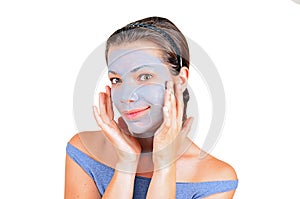 Young woman with clay facial mask