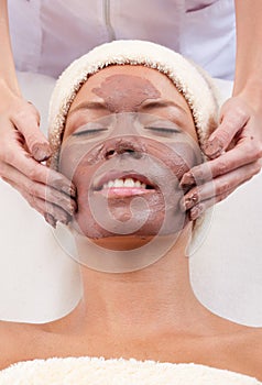 Young woman with clay facial mask.