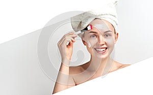 Young woman with clay facial mask. Skincare. Blonde woman smiling on white background. moisturizer mask