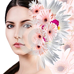 Young woman with clean skin over flowers.