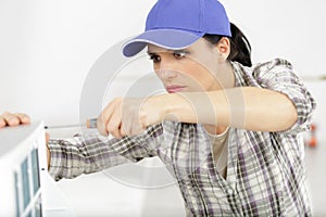 young woman cleaning air conditioning system at home
