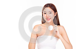 Young woman cleaning beauty face, using cotton pads Beautiful asian female showing clean cotton pad Smile face Attractive girl has