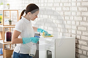 Young Woman Cleaning The Cabinet