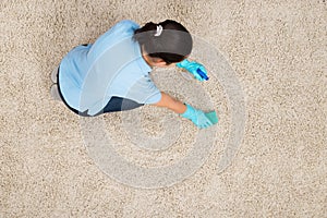 Young Woman Cleaning Carpet