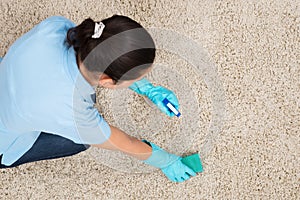 Young Woman Cleaning Carpet