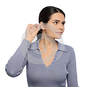 Young woman cleaning ear with cotton swab on white background