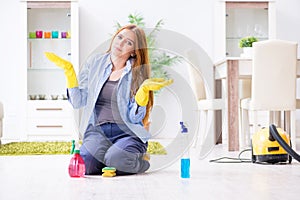 The young woman cleaning floor at home doing chores