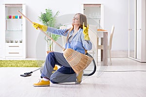 The young woman cleaning floor at home doing chores