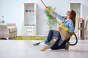 The young woman cleaning floor at home doing chores