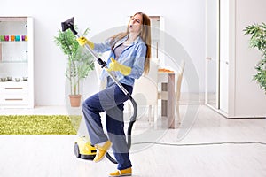 The young woman cleaning floor at home doing chores