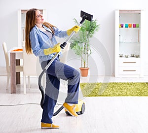 Young woman cleaning floor at home doing chores