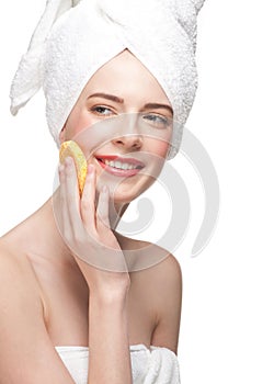 Young woman cleaning her face