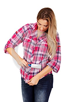 Young woman cleaning her shirt with lint roller