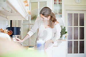Young woman cleaning the kitchen photo