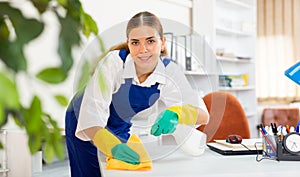 Young woman cleaning office