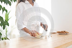 Young woman cleans the home with eco products.