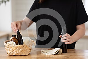 Young woman cleans the kitchen with eco products.