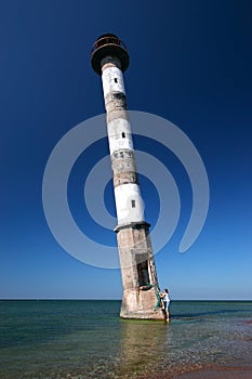 Young woman climbing into lighthouse.