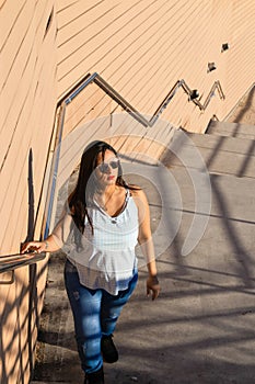 Young woman climbing stairs in a park