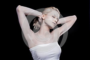 young woman with closed eyes posing with white makeup,