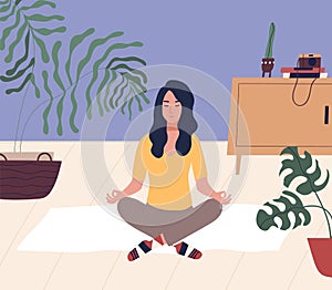 Young woman with closed eyes sitting cross legged on floor and meditating. Meditation, relaxation at home, spiritual