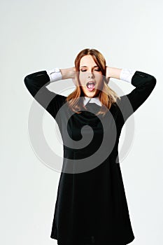 Young woman closing her ears and screaming