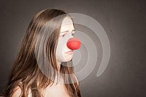 Young woman with a clown nose