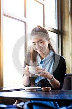 Young woman with coffee cup in cafe